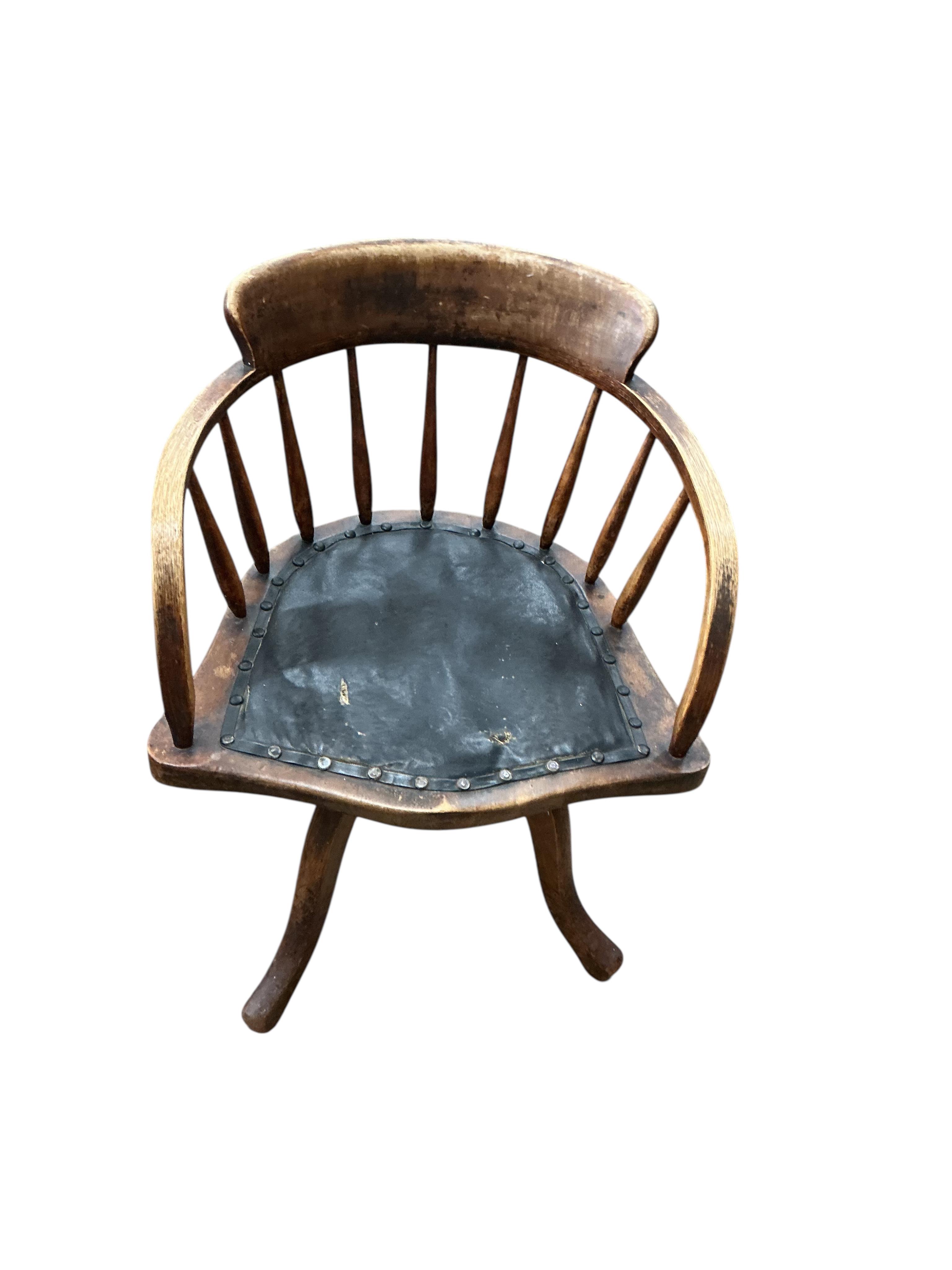 An early 20th century ash and beech revolving desk chair, width 55cm, depth 45cm, height 76cm